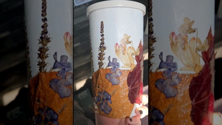 Photo of an oatmeal can covered in dried flowers