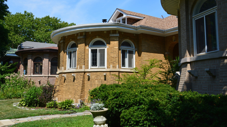 A street lined with Chicago style brick bungalows with round fronts.