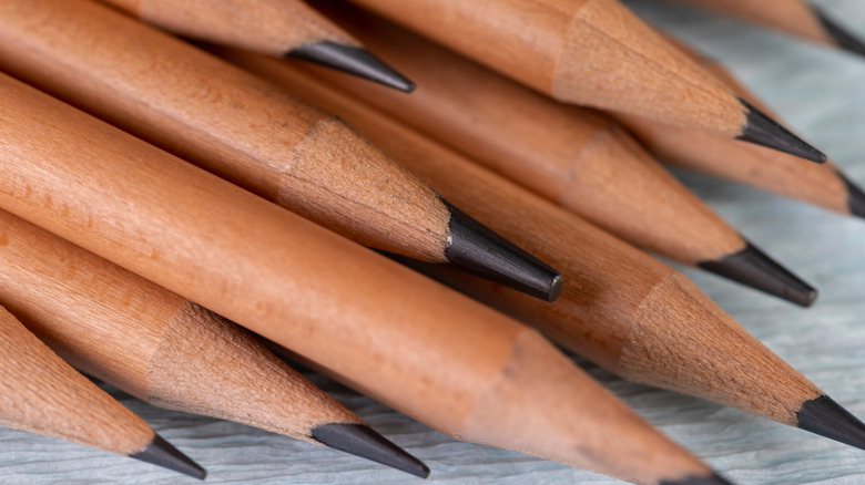 bundle of wooden pencils with black tips on a table