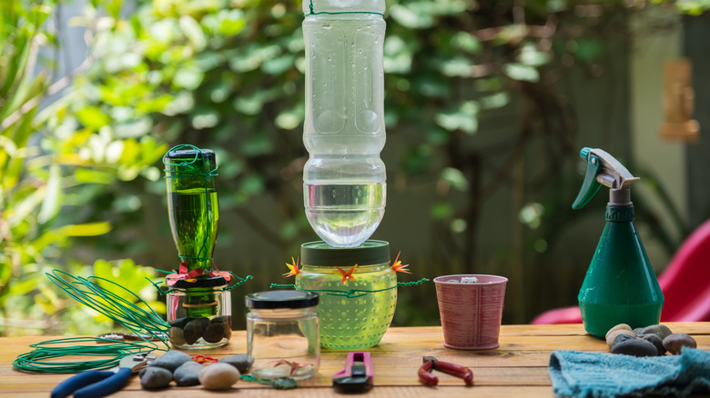 upcycled bottles and jars repurposed into hummingbird feeders with tools