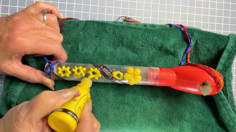 Woman crafting Valentine's chocolate container into DIY bird feeder