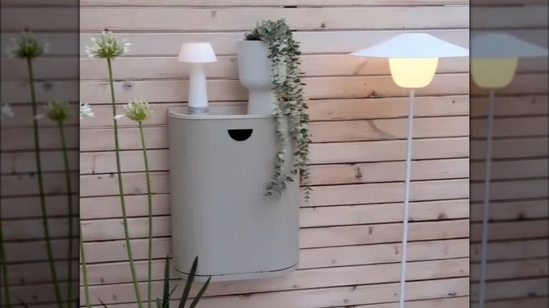 GÅRDSBUTIK bin on a wooden fence