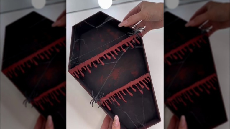 DIY coffin shelf with spiders and fake blood