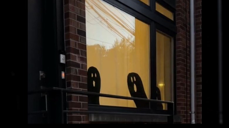 Ghost silhouettes in windows made from cardboard