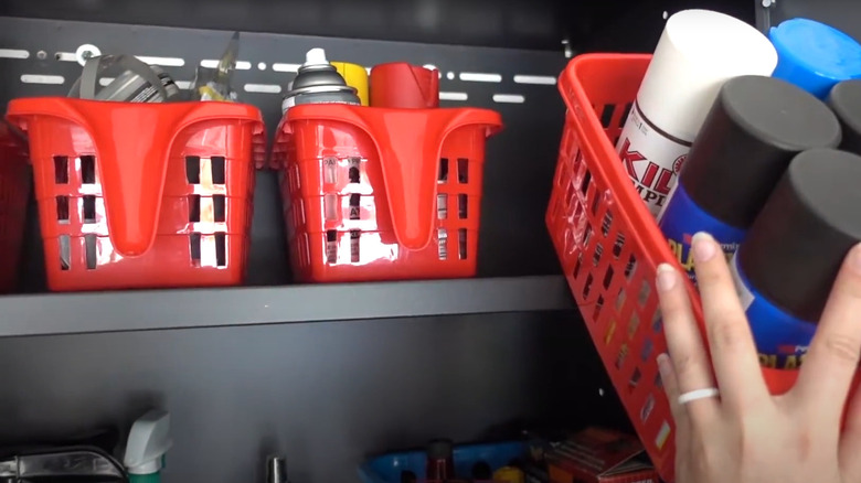 Red plastic locker bins with organized garage supplies