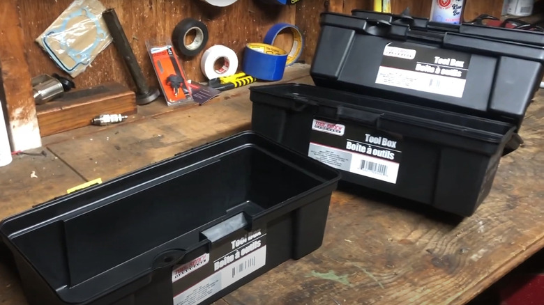 Empty Dollar Tree tool boxes on worktable in garage