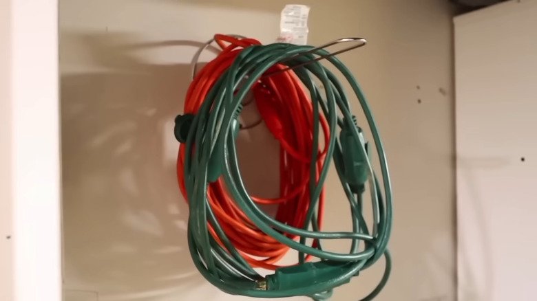 Hanging cords on outdoor paper towel holder in garage