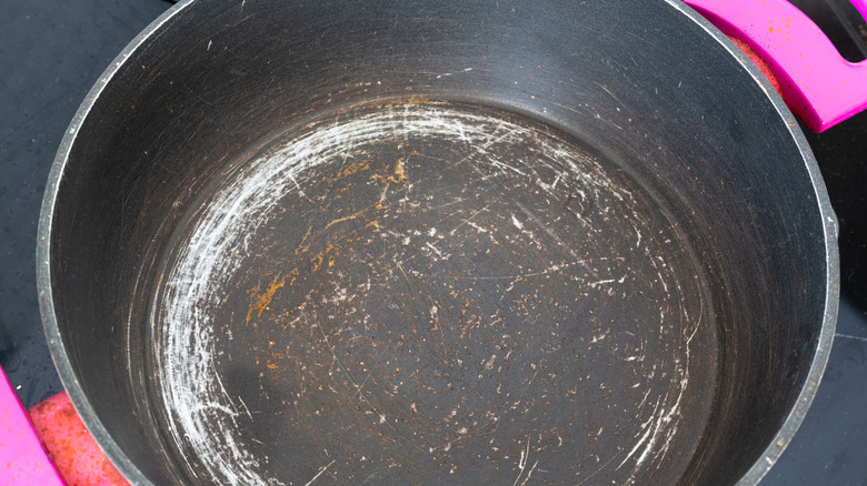 Old non-stick pan with pink handles