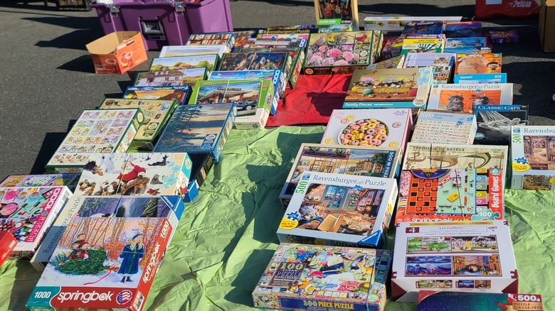 Pile of puzzles on the ground at a garage sale