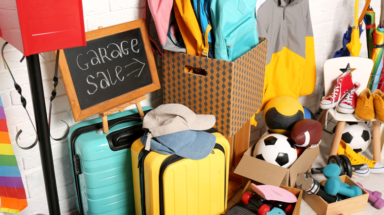 Pile of items with garage sale sign, including sporting goods