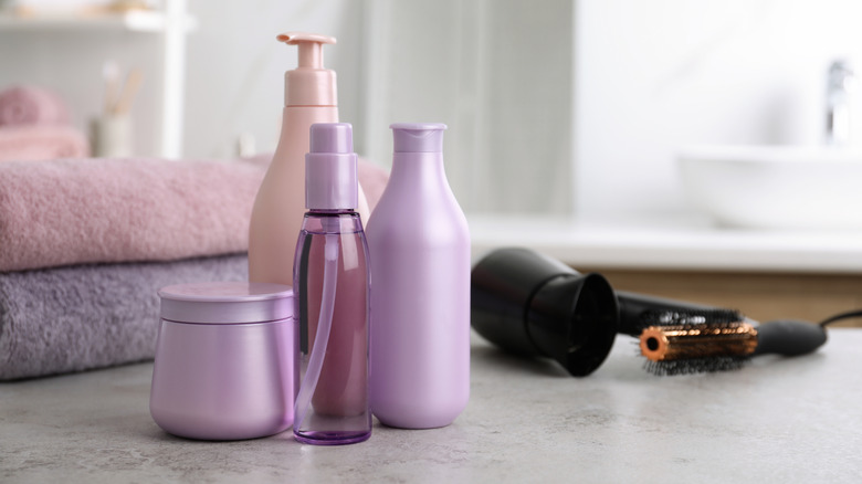Hair products and styling tools on a bathroom countertop
