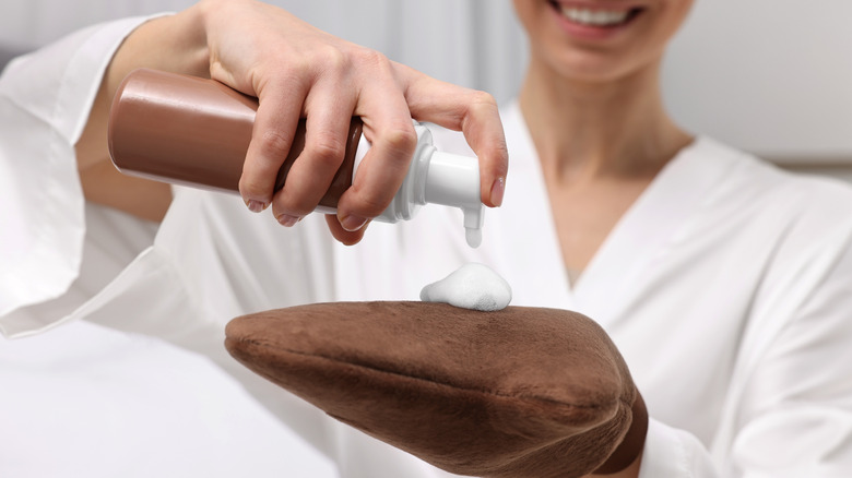 Woman using self-tanning product