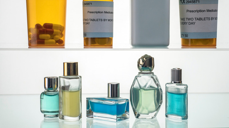 Bottles of perfume and cologne in a medicine cabinet