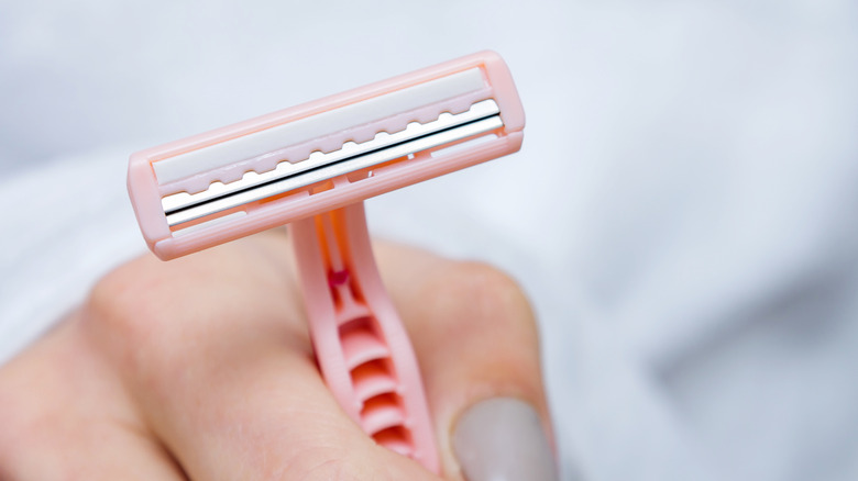 Woman holding a disposable personal razor