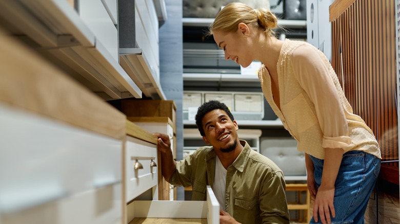 Couple selecting kitchen cabinets