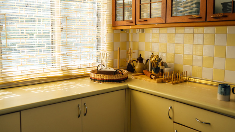 A vintage kitchen with yellow countertops