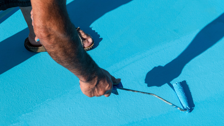 person stepping on freshly painted floor