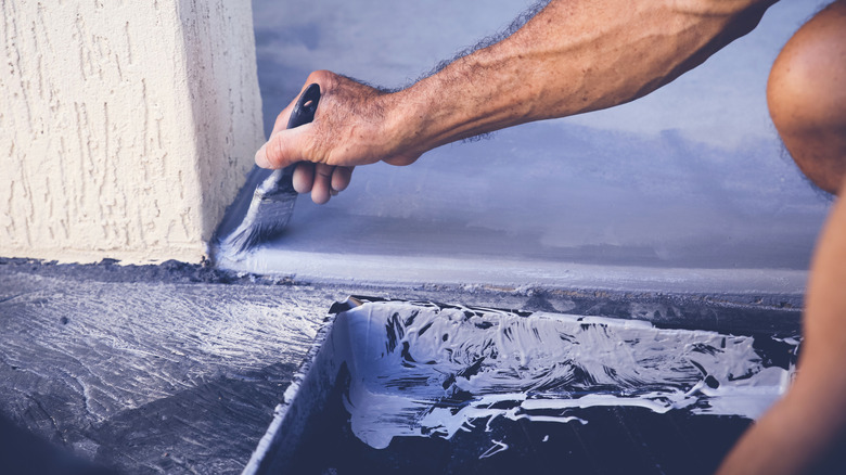painting floor with brush