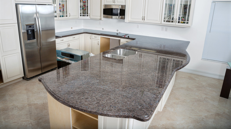 A polished granite countertop in a kitchen