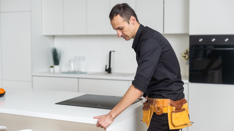 A man installing a countertop