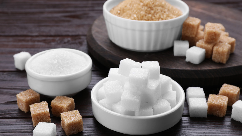 A wooden table with different types of sugar