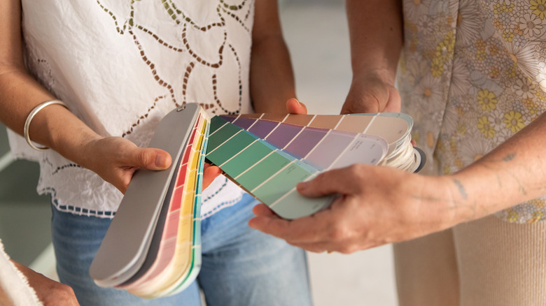 two people selecting from cabinet color samples