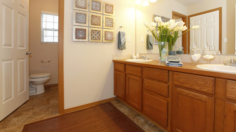 A bathroom with honey oak cabinetry