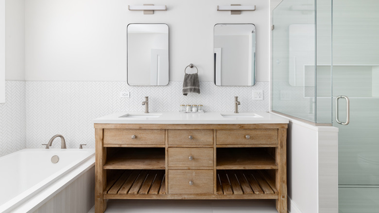 A bathroom with natural wood vanity shelves