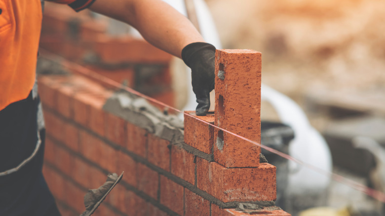 construction worker laying bricks