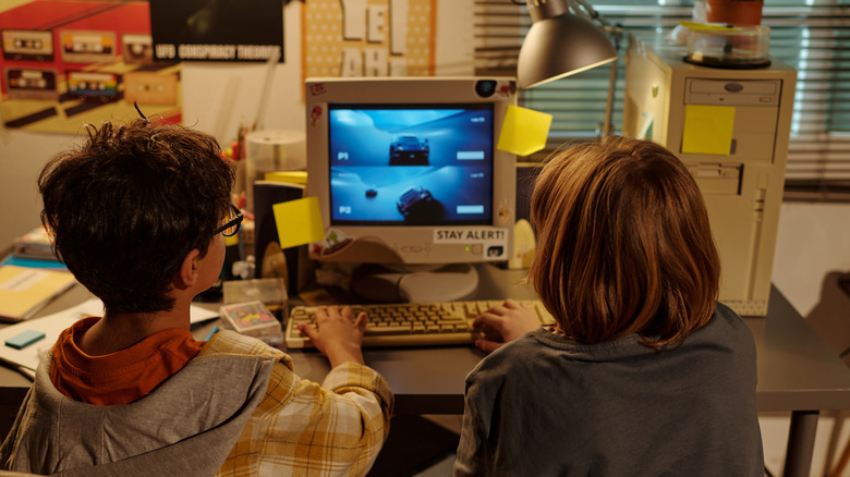 two kids playing video games on vintage computer screen