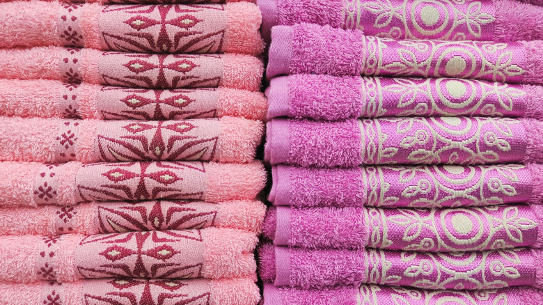 Two stacks of folded, brightly colored towels
