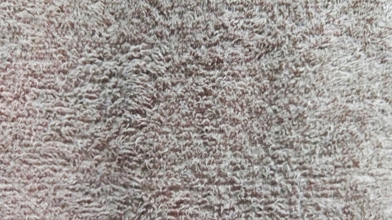 A close up of towel fabric with damaged, scratchy fibers