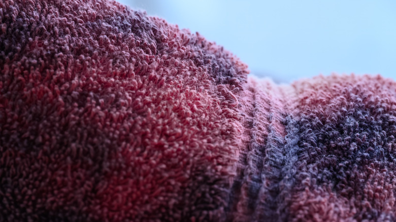 A dark-colored towel with bleach spots