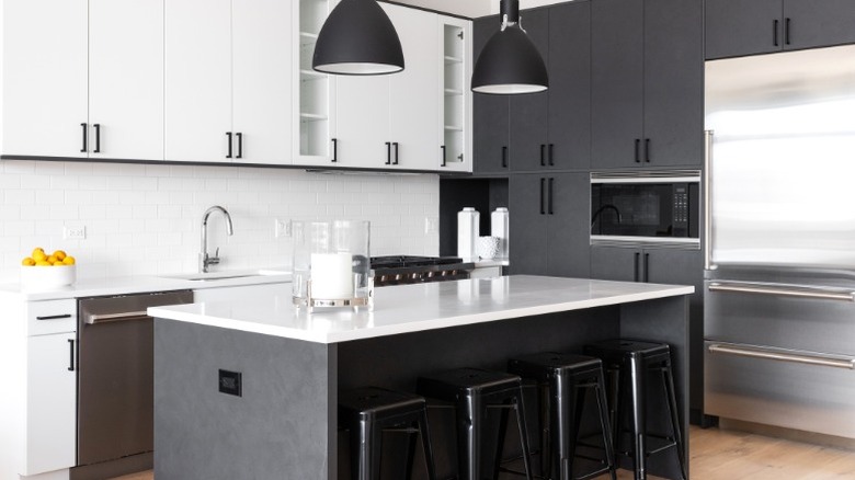 black pendant lights over island in modern kitchen