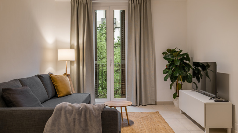 tall curtains in front of balcony window in small living room