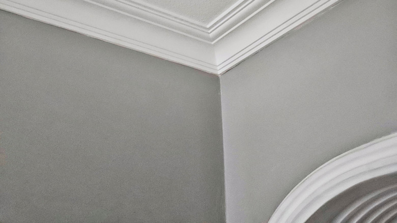 close-up of crown molding meeting a popcorn ceiling
