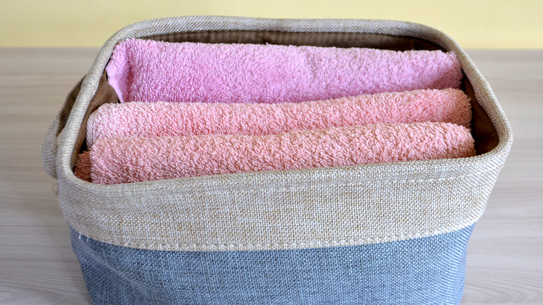 Fabric bin with towels folded in it