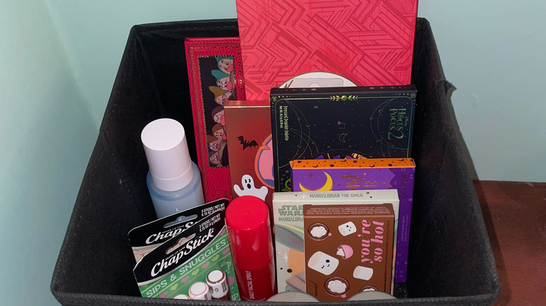 Fabric bin with makeup palettes and other makeup items