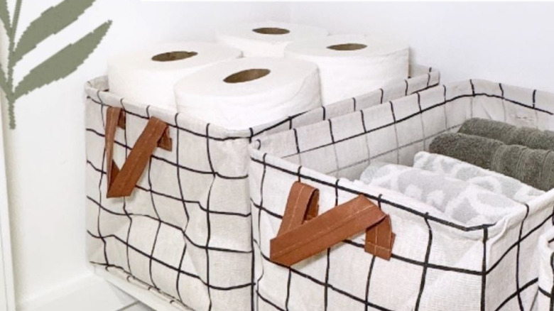 Rolls of toilet paper in a fabric storage bin