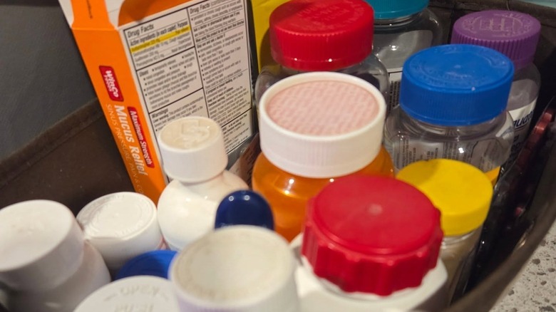 Bottles of medicine and vitamins in a fabric storage bin