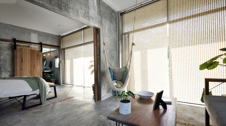 Modern industrial style home with sliding glass doors covered in patterned blinds