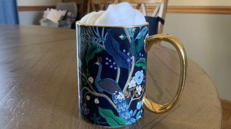Cotton balls in a coffee mug
