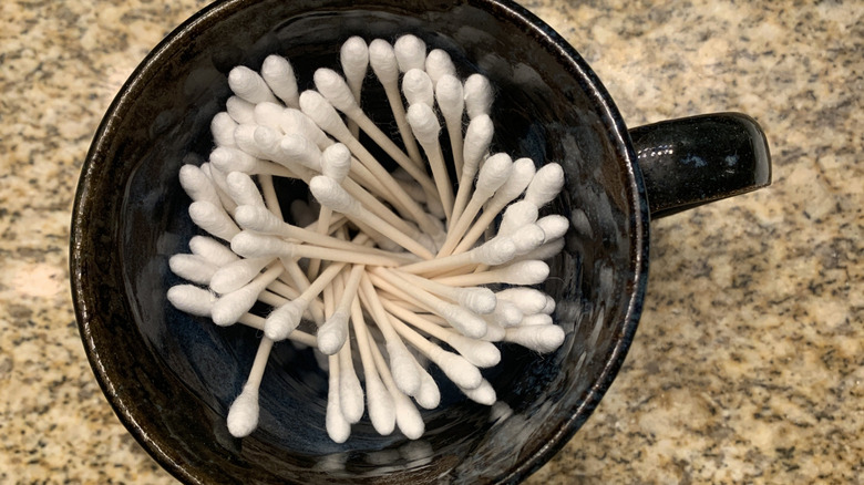 Q-tips in a coffee mug