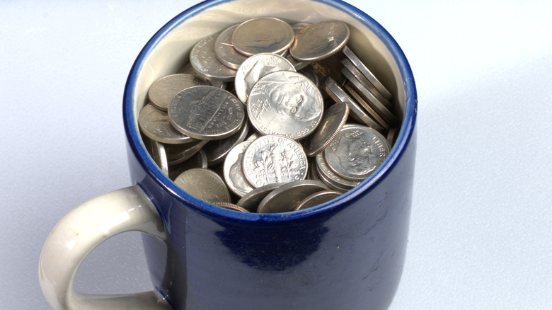 A mug holding loose change