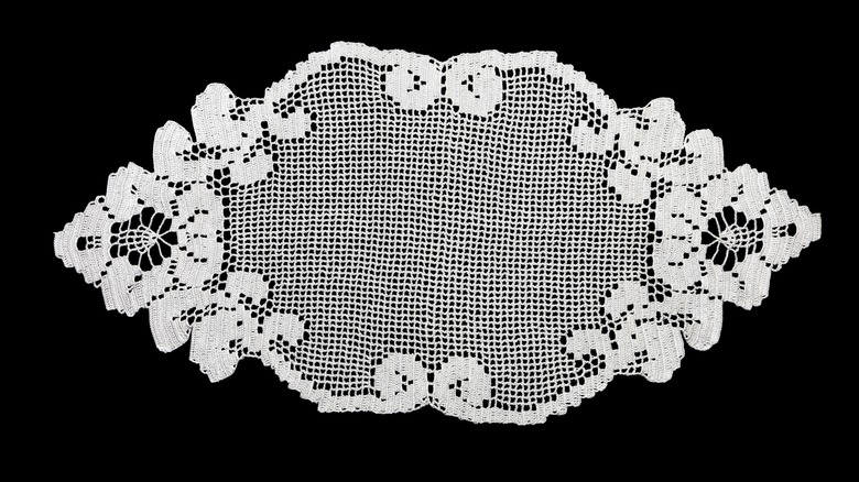 An example of a diamond shaped filet crochet on a black background.