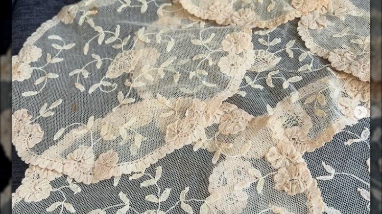 A piece of princess lace with machine made netting and colorful applique.