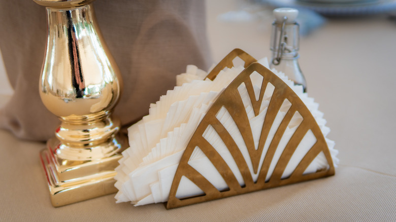 Chrome napkin holder on table with napkins inside