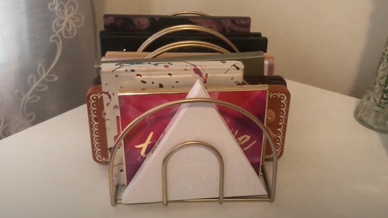 Napkin holder with makeup palettes