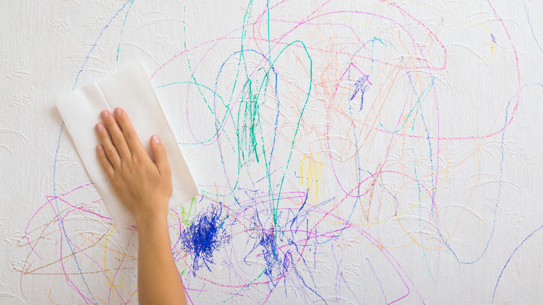 Wiping crayon off the wall