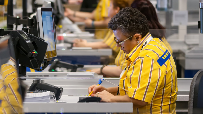 IKEA cashier writing something down